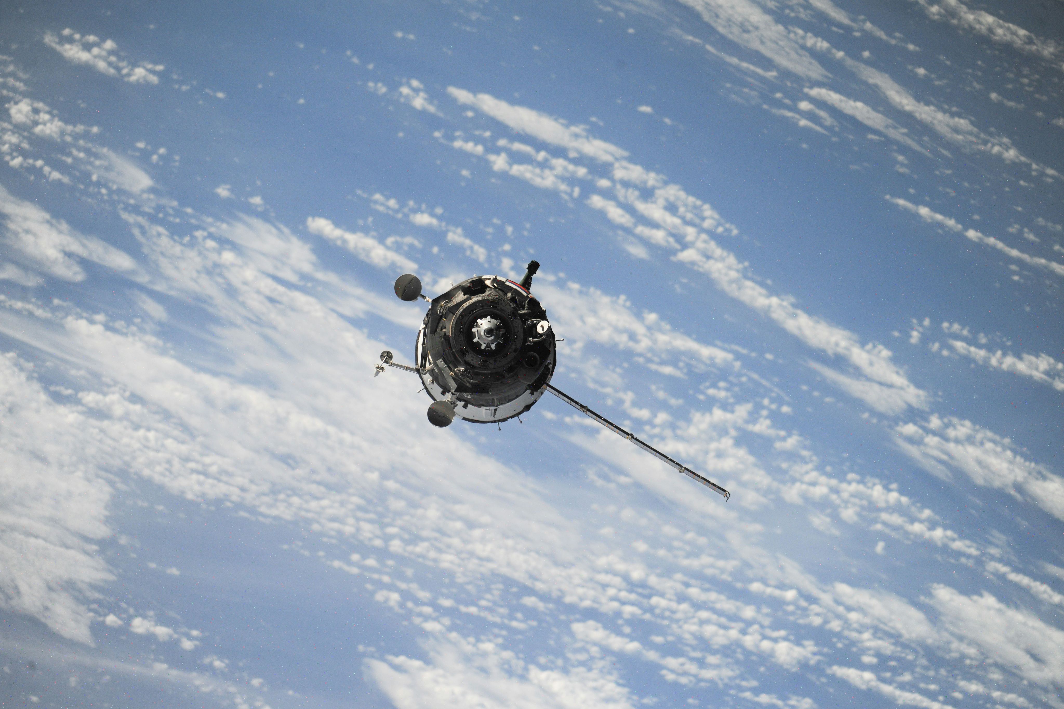 Background image shows a satellite in space above Earth's atmosphere.
